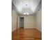 Bright dining room with hardwood floors, a modern chandelier, and detailed trim at 709 Stonehenge Pl, Jonesboro, GA 30236