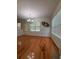 Dining room with hardwood floors, a view of the backyard, and a modern chandelier at 709 Stonehenge Pl, Jonesboro, GA 30236