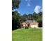 Quaint brick home boasts a well-manicured lawn, and charming entryway, nestled amidst lush trees and a vibrant blue sky at 709 Stonehenge Pl, Jonesboro, GA 30236
