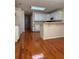 Spacious kitchen featuring white cabinets, an island bar, and hardwood floors at 709 Stonehenge Pl, Jonesboro, GA 30236