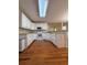 Well-lit kitchen features white cabinets, modern appliances, and bar seating at 709 Stonehenge Pl, Jonesboro, GA 30236