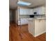 Bright kitchen featuring a breakfast bar, white cabinets, and modern appliances at 709 Stonehenge Pl, Jonesboro, GA 30236