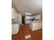 Spacious kitchen with white cabinetry, bar seating, and hardwood floors at 709 Stonehenge Pl, Jonesboro, GA 30236