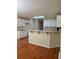 Bright kitchen featuring a breakfast bar, white cabinets, and hardwood floors at 709 Stonehenge Pl, Jonesboro, GA 30236