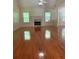 Spacious living room boasts gleaming hardwood floors, a charming fireplace, and an abundance of natural light streaming through the windows at 709 Stonehenge Pl, Jonesboro, GA 30236