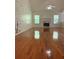 Expansive living room showcases gleaming hardwood floors, high ceilings, a charming fireplace, and an artistic tree design on the wall at 709 Stonehenge Pl, Jonesboro, GA 30236