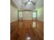 A bright main bedroom with hardwood floors, a ceiling fan, and recessed lighting at 709 Stonehenge Pl, Jonesboro, GA 30236