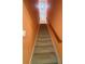 Carpeted stairwell with a wooden handrail at 709 Stonehenge Pl, Jonesboro, GA 30236