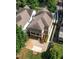 Aerial view of charming home with landscaped yard and driveway in a serene, wooded setting at 127 Oak Ln, Decatur, GA 30030
