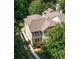 An aerial view of a 2-story home surrounded by lush, mature trees in a quiet neighborhood at 127 Oak Ln, Decatur, GA 30030