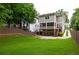 Expansive backyard featuring lush green lawn, a wooden fence, and an inviting exterior of the home at 127 Oak Ln, Decatur, GA 30030