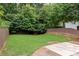 Fenced backyard with a lush lawn and mature trees, offering privacy and space for outdoor activities at 127 Oak Ln, Decatur, GA 30030
