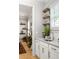 Stylish bar area featuring shaker cabinets, floating wood shelves, and a stainless steel sink at 127 Oak Ln, Decatur, GA 30030