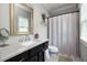 Bright bathroom showcasing a vanity with sink, mirror, and shower with patterned curtain at 127 Oak Ln, Decatur, GA 30030