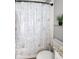 Charming bathroom features a patterned shower curtain, toilet, and a decorative plant at 127 Oak Ln, Decatur, GA 30030