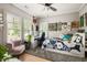 Bedroom area filled with eclectic decor, a grey rug, large windows, and ceiling fan at 127 Oak Ln, Decatur, GA 30030