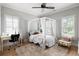 Stylish bedroom with natural lighting, a canopy bed, and neutral decor at 127 Oak Ln, Decatur, GA 30030