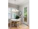 Bright dining area features a round table, chandelier lighting, and an exterior door to the outdoor deck at 127 Oak Ln, Decatur, GA 30030