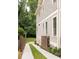Side view of a gray house featuring a driveway with a unique grass divider and privacy fence at 127 Oak Ln, Decatur, GA 30030