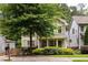 Two-story home with a welcoming front porch framed by lush bushes and a neatly kept lawn at 127 Oak Ln, Decatur, GA 30030