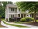 Charming two-story home with landscaped yard, inviting front porch, and private driveway at 127 Oak Ln, Decatur, GA 30030