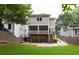 Exterior of home featuring a screened porch, 2-car garage, lush lawn, and wooden fence at 127 Oak Ln, Decatur, GA 30030