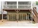 View of a two-car garage, lower level, under a screened porch and wooden steps to the backyard at 127 Oak Ln, Decatur, GA 30030