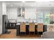 An open kitchen with modern stainless appliances, a large island, and a breakfast nook area at 127 Oak Ln, Decatur, GA 30030