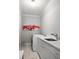 Laundry room with light-colored cabinets, light-colored countertops, tile floor, and gray walls at 127 Oak Ln, Decatur, GA 30030
