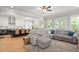 Open floor plan shows an updated kitchen with island seating and living area with hardwood floors at 127 Oak Ln, Decatur, GA 30030
