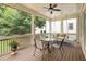 Screened porch with outdoor seating, ceiling fan, and swing, ideal for outdoor entertaining at 127 Oak Ln, Decatur, GA 30030