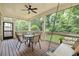 Inviting screened porch features a dining table set, ceiling fan, and a relaxing porch swing at 127 Oak Ln, Decatur, GA 30030