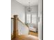Bright foyer with wooden staircase, complemented by a window bench and modern chandelier at 127 Oak Ln, Decatur, GA 30030