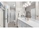 Bright bathroom featuring a white vanity with a large mirror and a glass-enclosed shower at 340 Helens Manor Dr, Lawrenceville, GA 30045