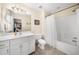Bright bathroom with a single sink vanity, white shower curtain, tile floors, and white fixtures at 340 Helens Manor Dr, Lawrenceville, GA 30045