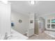 Bathroom with tiled floors, glass block window, shower, and soaking tub at 340 Helens Manor Dr, Lawrenceville, GA 30045