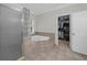 Bathroom featuring a glass shower enclosure, tub, and access to a walk-in closet at 340 Helens Manor Dr, Lawrenceville, GA 30045