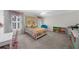 Bright bedroom with patterned bedding, white walls, a window seat, and a colorful bookshelf at 340 Helens Manor Dr, Lawrenceville, GA 30045