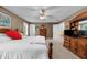 Comfortable bedroom featuring neutral walls, carpet, ceiling fan, and a wooden bed frame with white bedding at 340 Helens Manor Dr, Lawrenceville, GA 30045