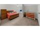 Bedroom with a wooden bed frame, carpet, neutral walls, and a colorful dresser at 340 Helens Manor Dr, Lawrenceville, GA 30045