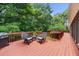 Outdoor deck with outdoor seating, grill, and view of lush trees at 340 Helens Manor Dr, Lawrenceville, GA 30045