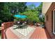 Outdoor deck featuring seating, table, umbrella, rug, and lush greenery at 340 Helens Manor Dr, Lawrenceville, GA 30045