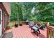 Outdoor deck with outdoor seating, grill, and view of lush trees at 340 Helens Manor Dr, Lawrenceville, GA 30045