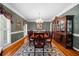 Formal dining room with a large table, ornate hutch, and natural light from the windows at 340 Helens Manor Dr, Lawrenceville, GA 30045