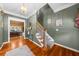 Entryway featuring a staircase, hardwood floors, and a glimpse into the living room at 340 Helens Manor Dr, Lawrenceville, GA 30045