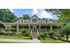 Beautiful brick home with a large front porch, white columns, and well-manicured landscaping at 340 Helens Manor Dr, Lawrenceville, GA 30045