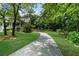 Beautiful home featuring a winding driveway, large front yard, and lush landscaping at 340 Helens Manor Dr, Lawrenceville, GA 30045