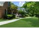 Sprawling green lawn leading to a charming home with a covered front porch and walkway at 340 Helens Manor Dr, Lawrenceville, GA 30045