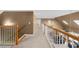 Upstairs hallway with carpet, skylights, white railings, and stairs to the floor below at 340 Helens Manor Dr, Lawrenceville, GA 30045