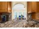 Modern kitchen with granite countertops and stainless steel appliances overlooking the dining area at 340 Helens Manor Dr, Lawrenceville, GA 30045